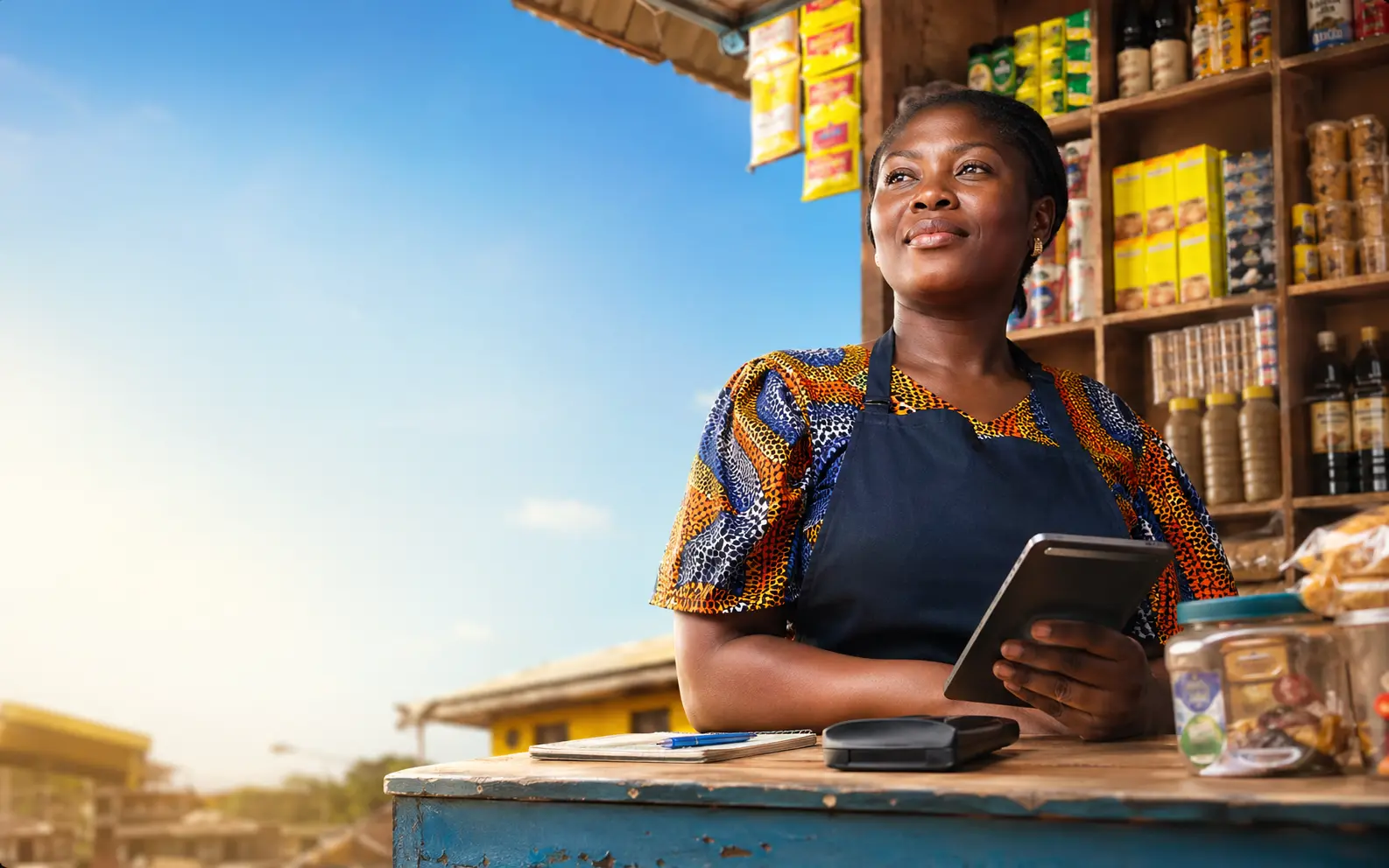 Confident shop owner at a bright counter with a digital ledger